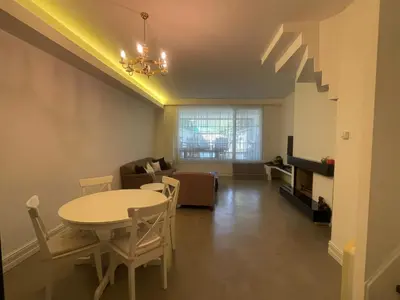 a living room with a table and a couch at Villa Orange in Istanbul