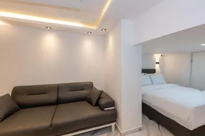 a small bedroom with a bed and a couch at Boutique 360 Suite in Istanbul