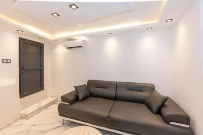 a leather couch in a room with a wall at Boutique 360 Suite in Istanbul