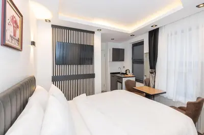 a hotel room with a white bed and a desk at Boutique 360 Suite in Istanbul