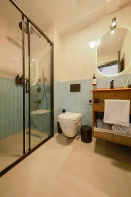 a bathroom with a toilet and a glass shower at Pastel İstanbul in Istanbul
