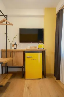 a yellow dishwasher in a kitchen with a desk at Pastel İstanbul in Istanbul