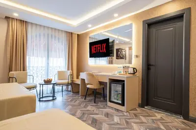 a hotel room with a table and a television on the wall at 216 Star in Samandra