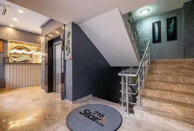 a lobby with a staircase and a stair rug at 216 Star in Samandra