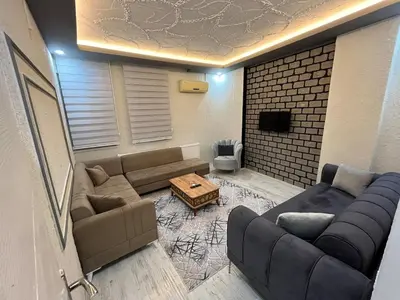 a living room with a couch and a table at Poyraz suit in Bursa