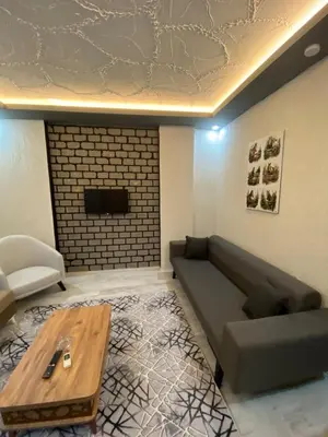 a living room with a couch and a table at Poyraz suit in Bursa