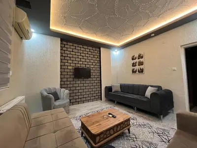 a living room with a couch and a coffee table at Poyraz suit in Bursa
