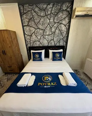 a bed in a room with a pep rally pillow at Poyraz suit in Bursa