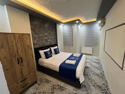 a bedroom with a bed with blue and white pillows at Suit 2 in Bursa
