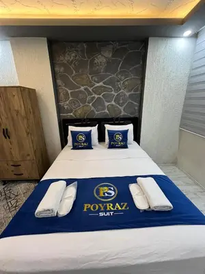 a hotel room with a pownal crest on the bed at Suit 2 in Bursa