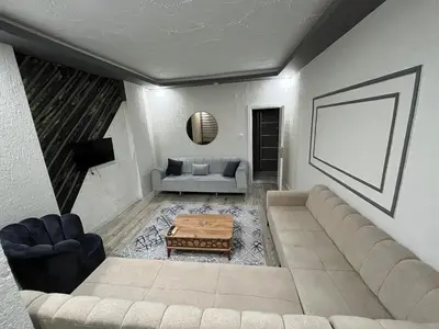 a living room with a couch and a table at Suit 2 in Bursa