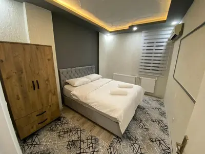 a small bedroom with a bed and a wooden cabinet at Suit 4 in Bursa