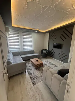 a living room with couches and a coffee table at Suit 4 in Bursa