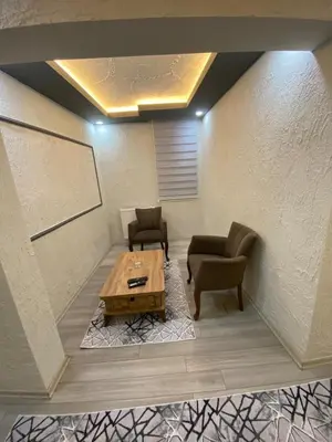 a room with two chairs and a wooden table at Poyraz suit in Bursa