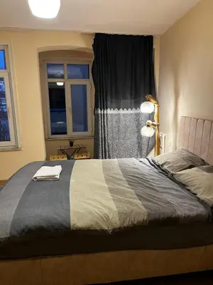 a bedroom with a bed with a lamp and a window at White Lotus Suites in Istanbul