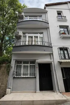 a white building with a balcony and a door at White Lotus Suites in Istanbul