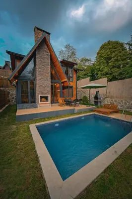 a house with a swimming pool in front of a house at Sapanca Grandwooden Deluxe in Sapanca