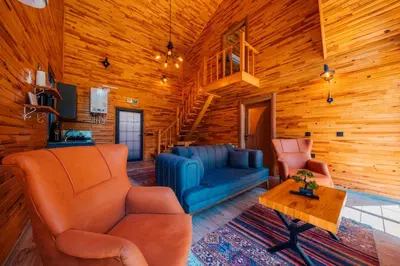 a living room with a blue couch and two chairs at Sapanca Grandwooden Deluxe in Sapanca