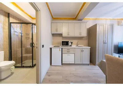 a small kitchen with a sink and a microwave at Taksim Studio Apart in Istanbul
