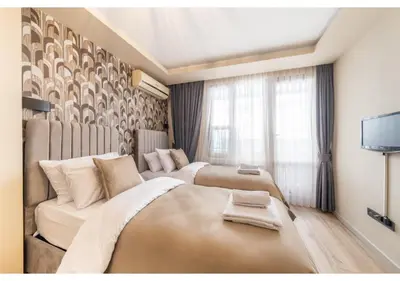 a hotel room with two beds and a couch at Taksim Studio Apart in Istanbul