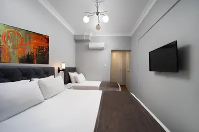 a bedroom with two beds and a flat screen tv at Galley Port in Istanbul