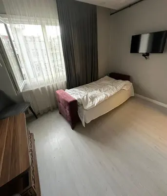 a bedroom with a bed and a large window at Cihangir Galataport Hotel in Istanbul