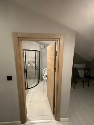 an open door to a bathroom with a toilet at Cihangir Galataport Hotel in Istanbul