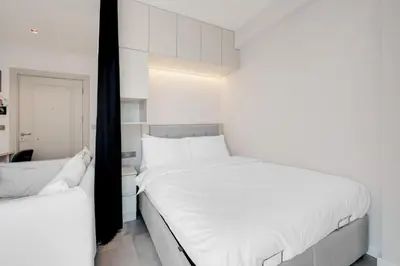 a bedroom with two beds with white sheets at Newly Constructed in Kadikoy Quake-Resistant-AC in Istanbul