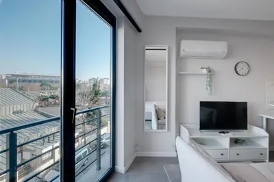 a living room with a tv and a balcony at Newly Constructed in Kadikoy Quake-Resistant-AC in Istanbul