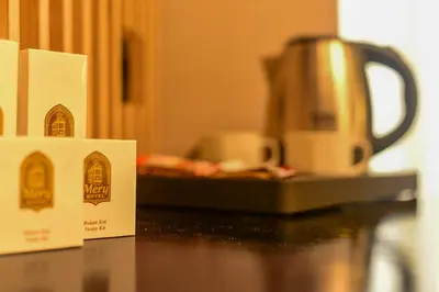 a coffee pot sitting on a counter next to a table at Mery Hotel İstanbul in Istanbul