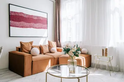 a living room with a couch and a glass table at Lovely City Apartment Steps Away from Galata Tower in Istanbul
