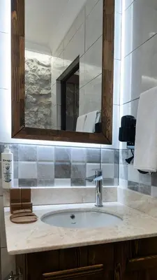 a bathroom counter with a sink and a mirror at Magical House Hotel in Çatalca