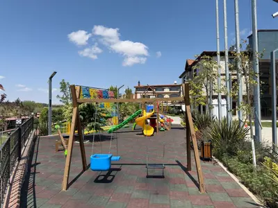 a playground with a slide and a swing at Magical House Hotel in Çatalca