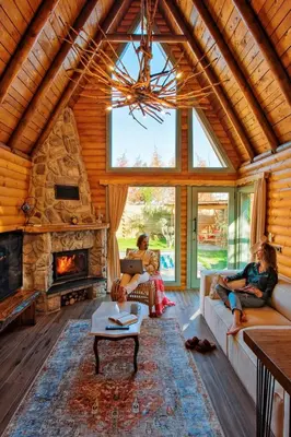 a group of people sitting in a living room with a fireplace at Rast Sapanca Bungalov in Sakarya