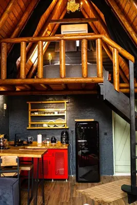 a kitchen with a wooden table and a wooden ceiling at Rast Sapanca Bungalov in Sakarya