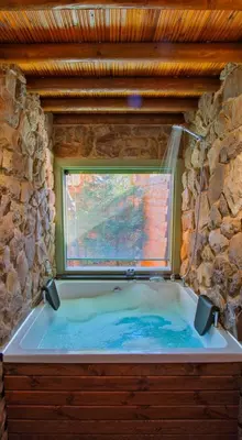 a large bath tub in a room with a window at Rast Sapanca Bungalov in Sakarya