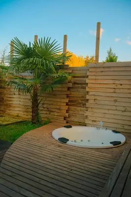 a bath tub sitting on a deck next to a wooden fence at Rast Sapanca Bungalov in Sakarya