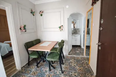 a dining room with a table and green chairs at Ayasofya Bella Vista APART in Istanbul