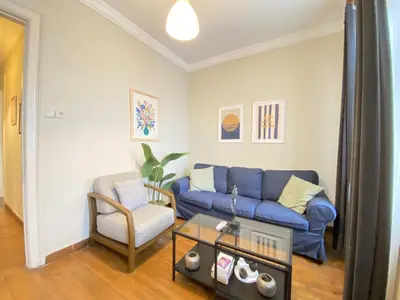 a living room with a blue couch and a chair at Charming Vintage 3BR in the Heart of Beyoğlu in Istanbul