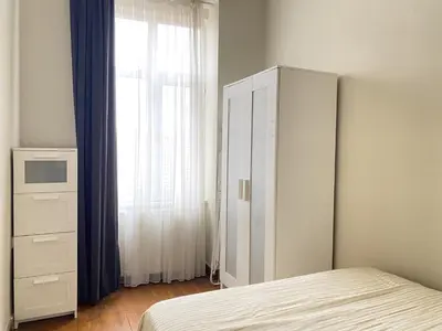 a bedroom with a bed and a dresser and a window at Charming Vintage 3BR in the Heart of Beyoğlu in Istanbul