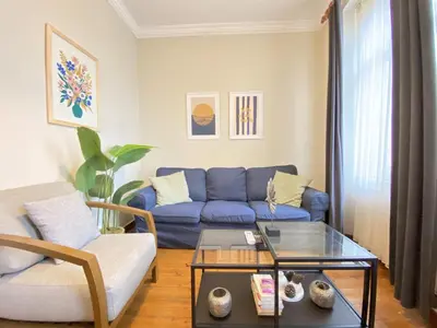 a living room with a blue couch and a table at Charming Vintage 3BR in the Heart of Beyoğlu in Istanbul