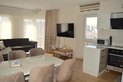 a living room with a table and a living room with a couch at King Suite SN20 in Esenyurt