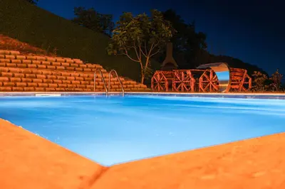 a large swimming pool with chairs and a fountain at ayrıkvadi panorama in Serdivan