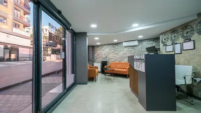a lobby with a waiting room with a bench and a sign at Nomad Hub Suit İstanbul in Istanbul