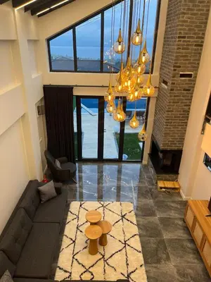 a living room with a couch and a chandelier at Sapanca modern in Sapanca