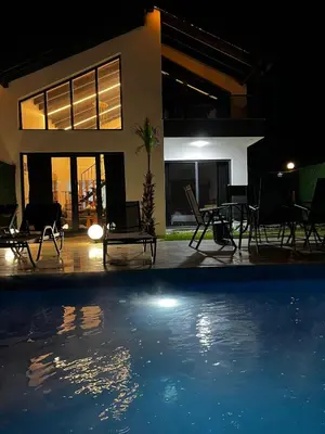 a swimming pool in front of a house at night at Sapanca modern in Sapanca