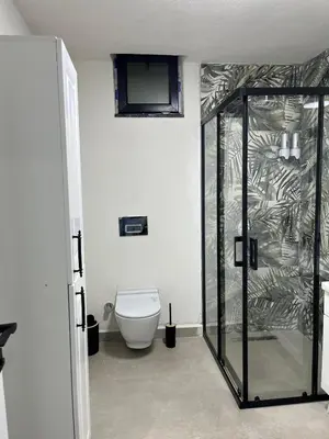 a bathroom with a toilet and a glass shower at Sapanca modern in Sapanca