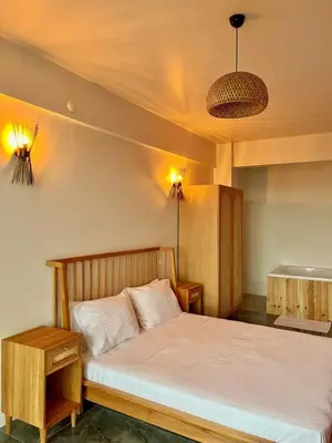 a bedroom with a bed and a table and lights at Sapanca modern in Sapanca
