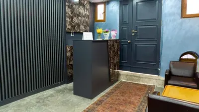 a lobby with a black door and a table with flowers at Miller Home's in Istanbul