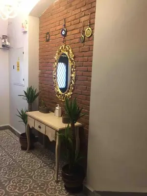 a room with a table and a mirror on a brick wall at Ozcans Pera Flats 2 in Istanbul